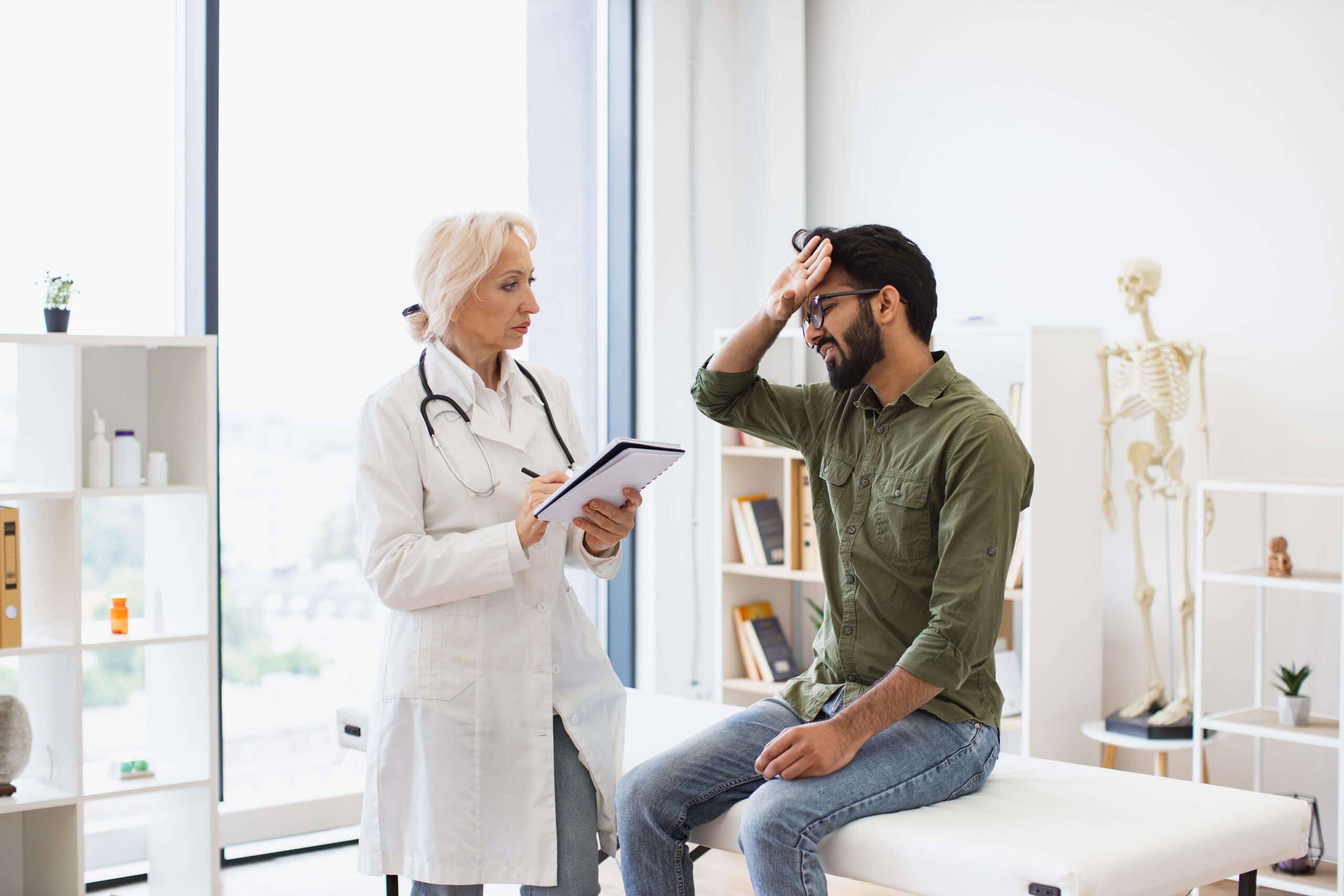 Elder physician giving recommendations and writing prescription. cognitive behavioral therapy los angeles